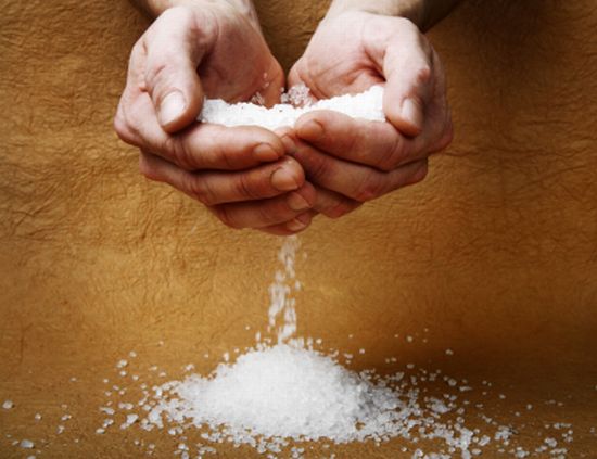 hands pouring salt