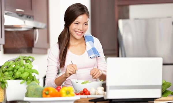 Cooking woman using computer