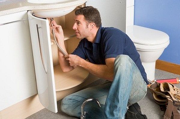 Plumber working on sink