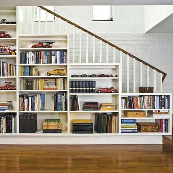 book shelve on the wall running along the staircase