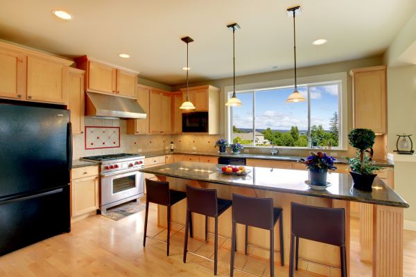 Luxury classic wood kitchen with island and chairs.