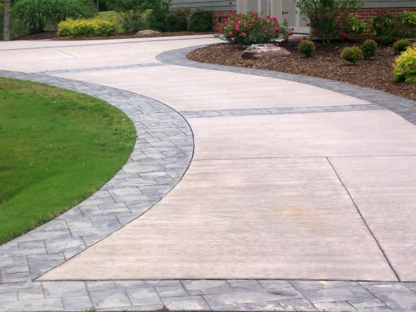 Refinished concrete driveway with custom inlay stamping