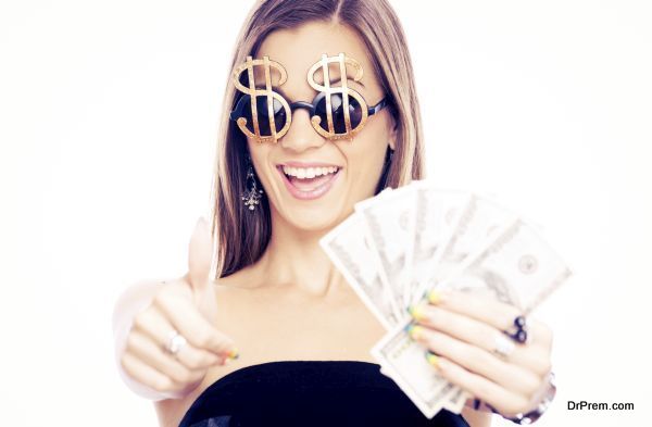 Young woman showing ok and holding Dollars