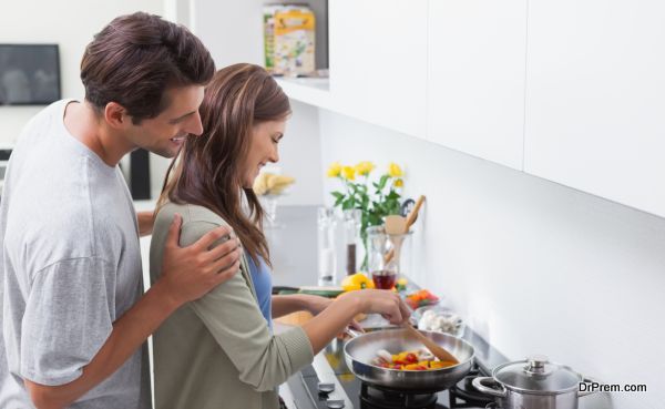 Man looking at his wife cooking