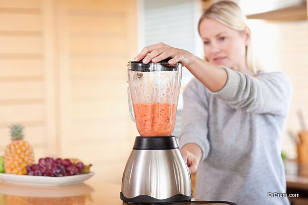 Side view of blender chopping fruits