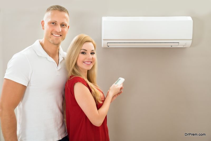 Couple With Remote Control Air Conditioner