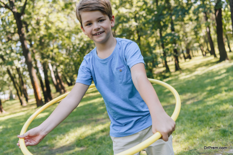 boy holding hula hoops