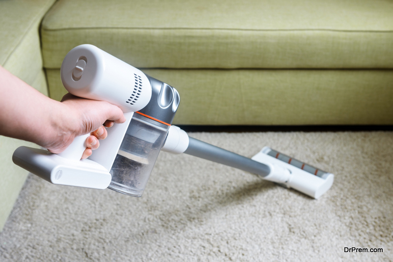 Wireless vacuum cleaner used on carpet in room
