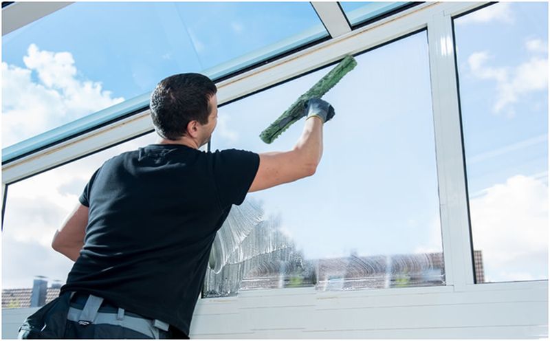 man cleaning windows 