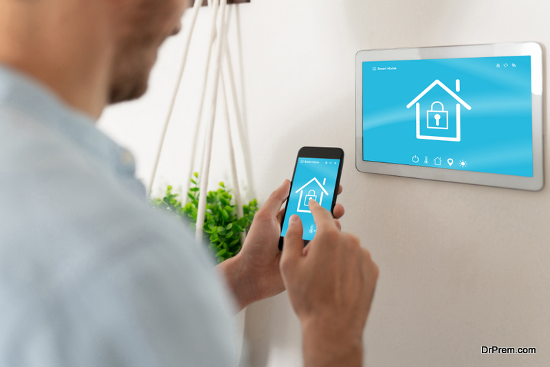 Closeup of a young man securing his smart home and locking his doors with his smartphone