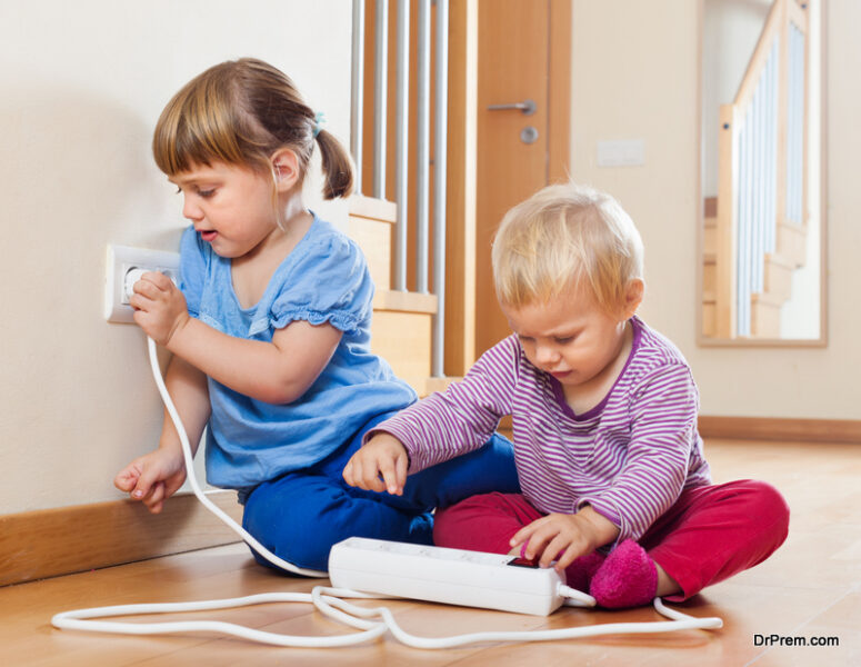 Two children at on floor playing with adapter plug