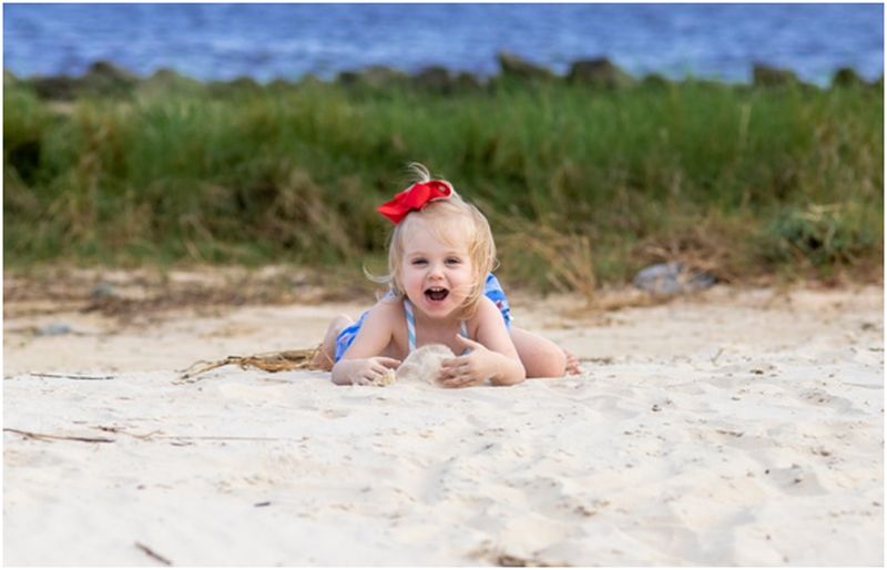 toddler girl playing with sand