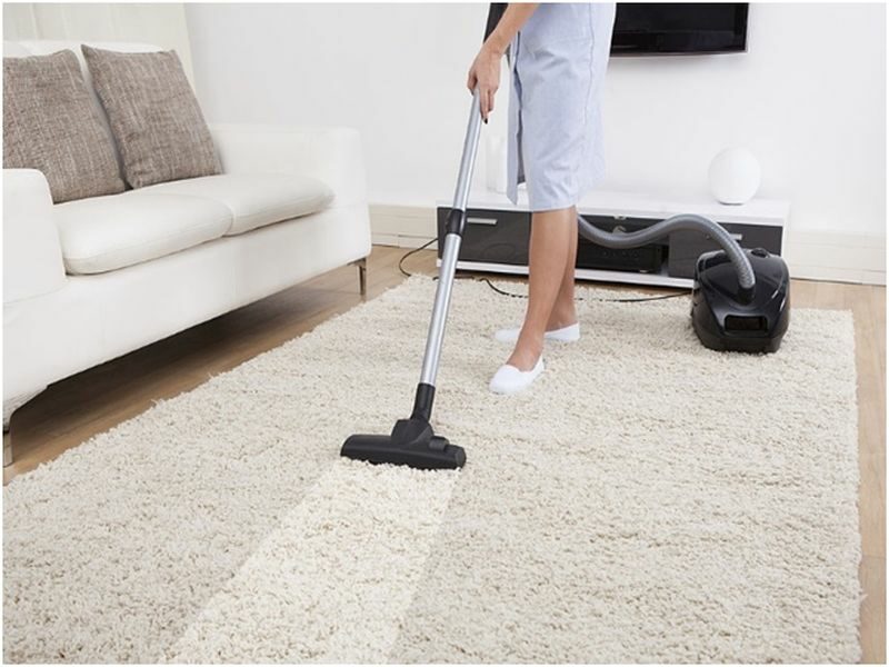 woman cleaning carpet