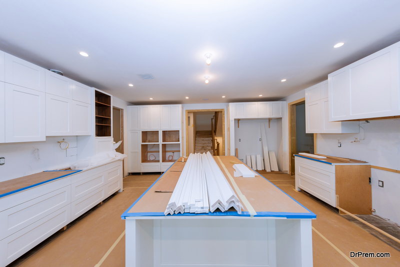White of kitchen wooden cabinets with contemporary look of installation base for island in center